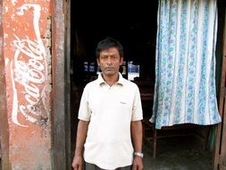 man at the entrance to a cafe in Nepal