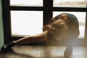 girl photographs legs near the window