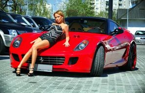 picture of girl posing on the background of red ferrari