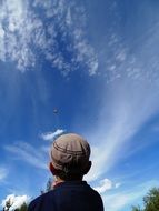 man launches a kite