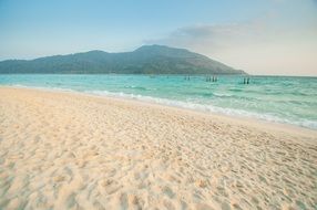 sandy beach with blue water in thailand