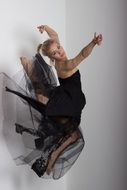 Beautiful young Girl dancing in black dress, top view