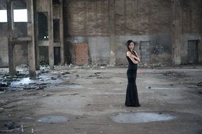 young girl in black long dress in abandoned building