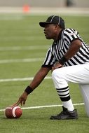 american football referee in striped shirt