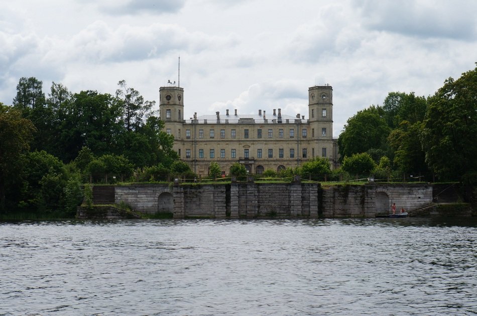 Beautiful palace among the green trees on the coast in Gatchina, Russia