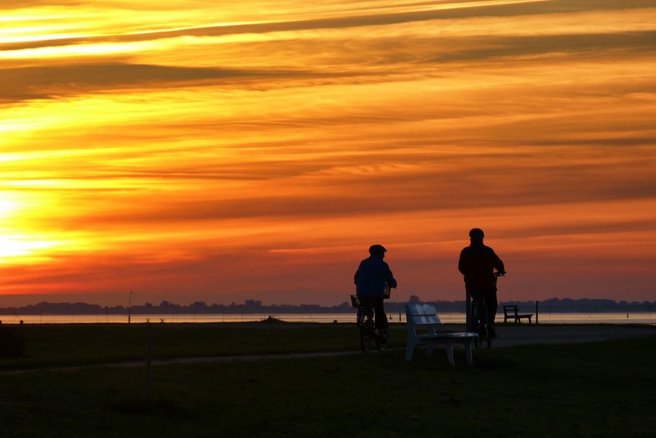 two bikers on the beach of the wadden sea