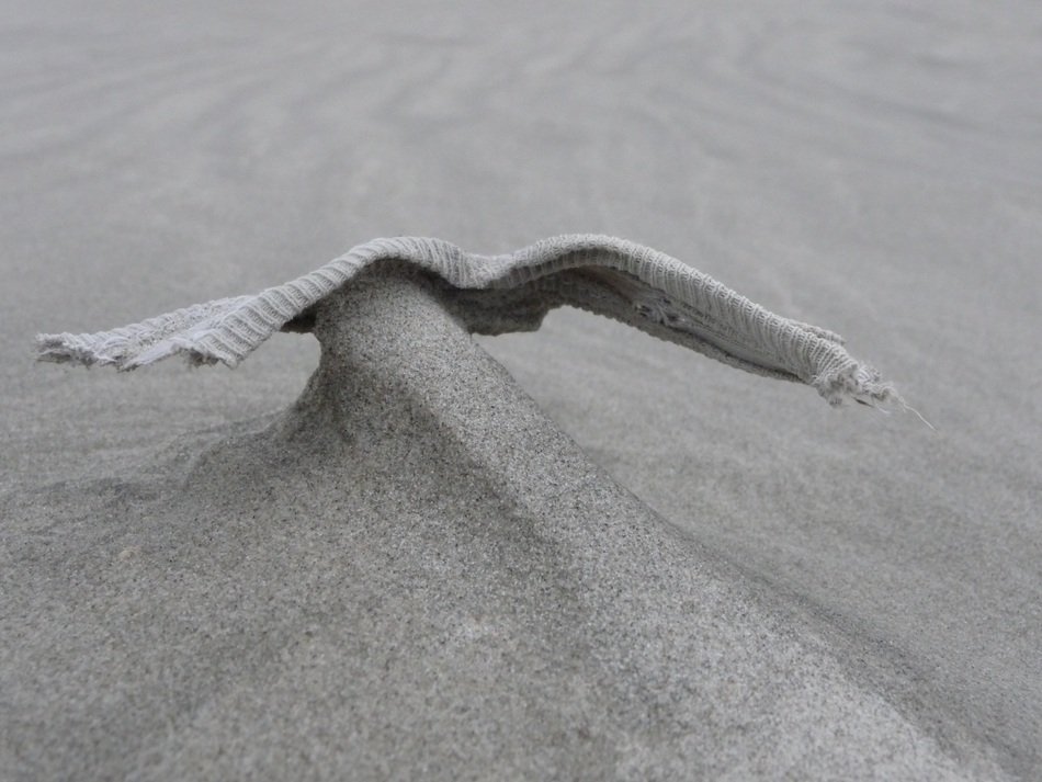figure with wings in the sand