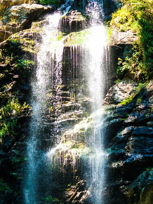 waterfall among the rocks in austria under the bright sun