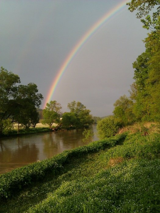 rainbow over the river in the sun