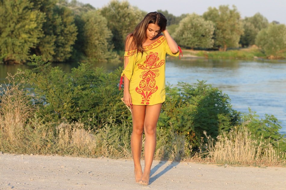 girl in summer dress near the pond