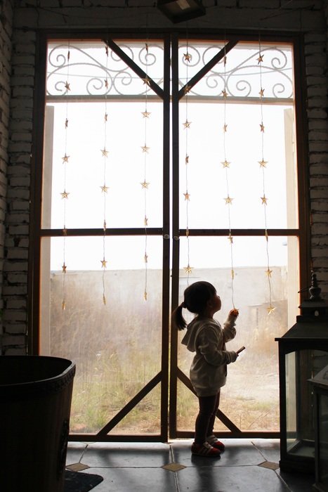 Silhouette of the girl near the window