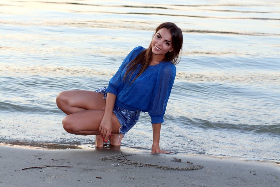 sensual girl near the water in the evening