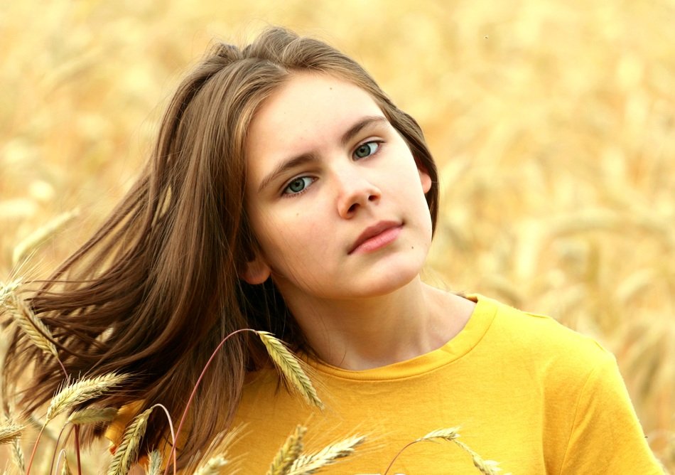 young long haired Girl in Wheat Field