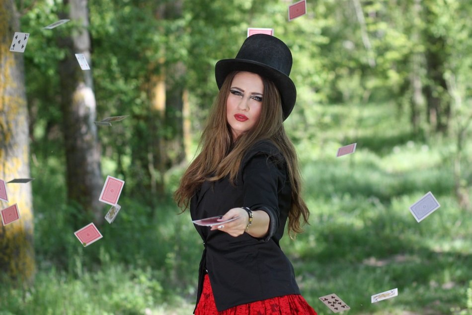 woman in topper with playing cards