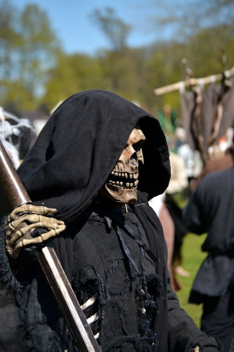 young man in a death suit at a festival