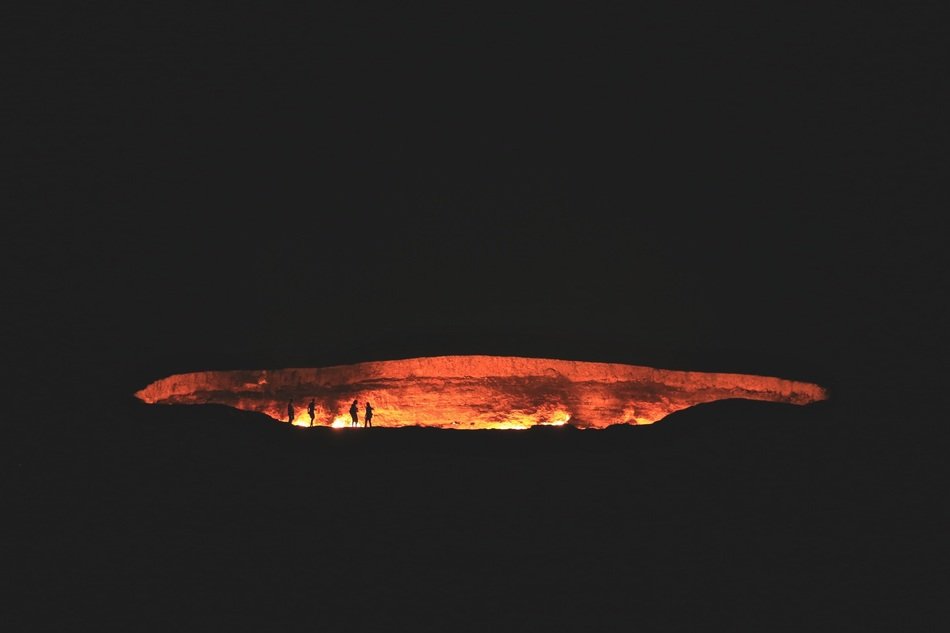 people silhouette near volcano crater