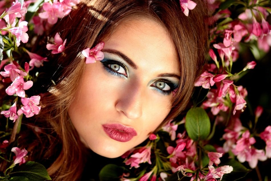 girl with beautiful eyes among the flowers
