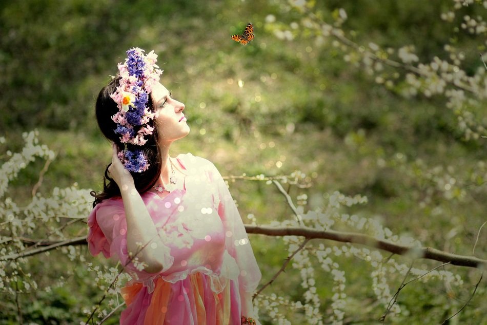 woman in colorful dress with floral wreath among the colorful nature