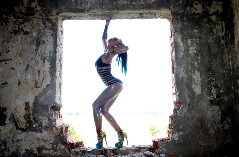 slim girl posing among the ruins