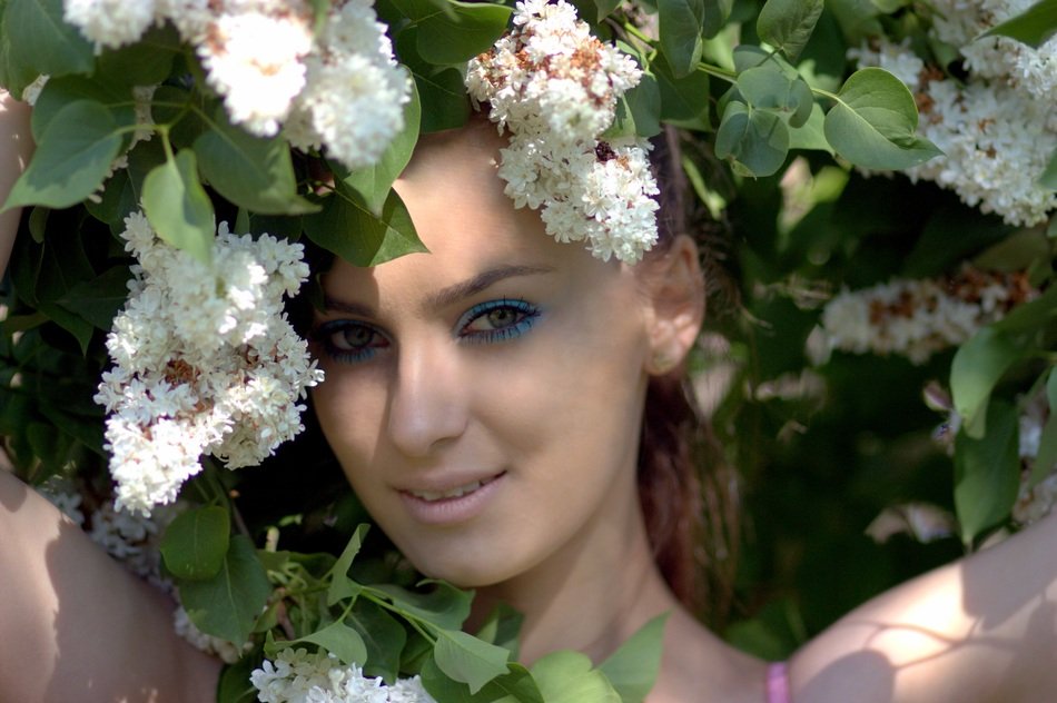 Girl in lilac flowers portrait