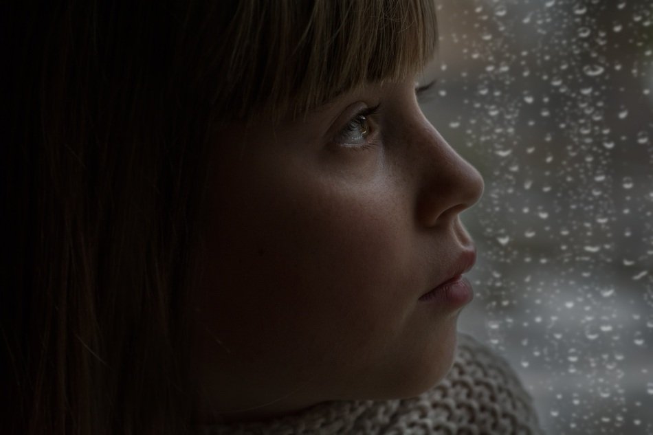 girl near the wet window