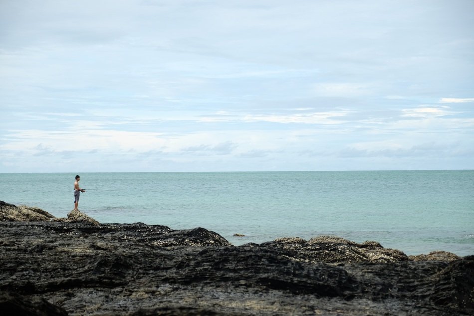 man fishing in the ocean