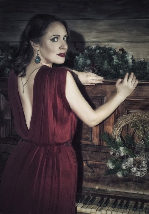 girl posing near the piano