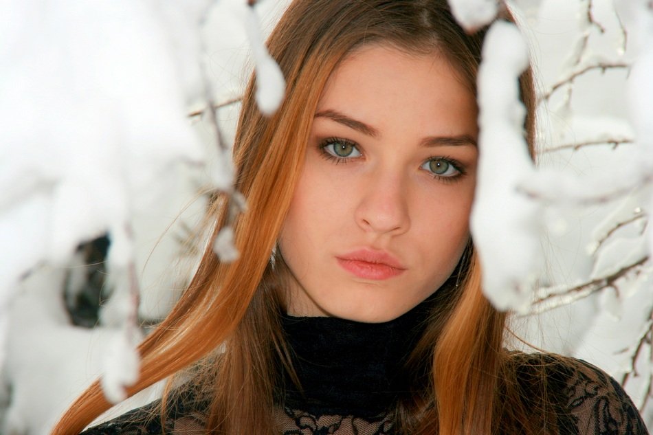 winter portrait of a beautiful girl among the snow