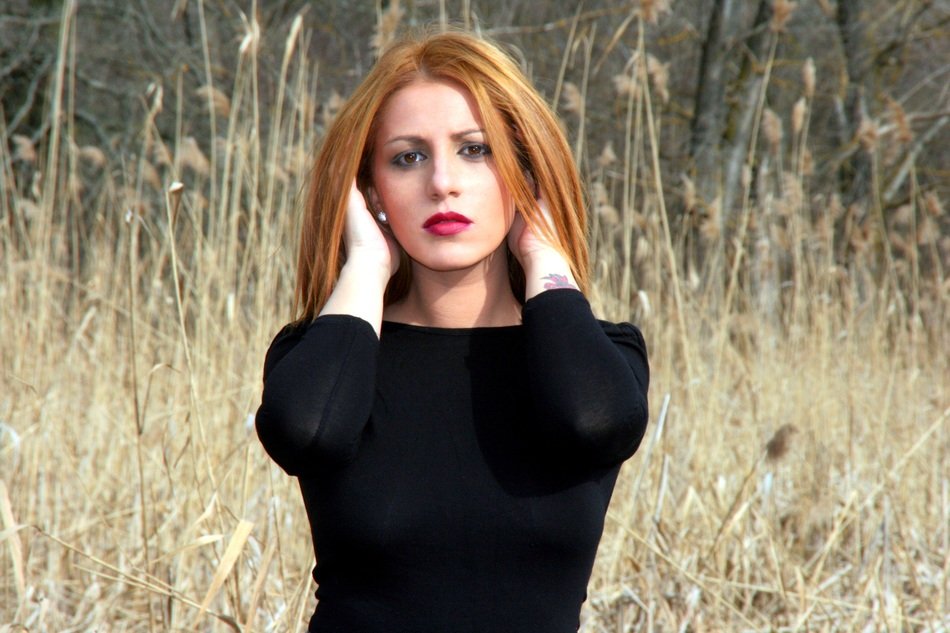 Girl with the brown eyes near the reed