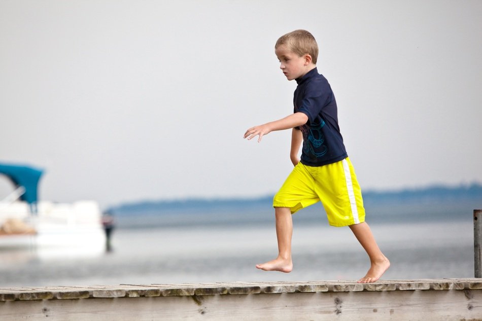 young boy running around in Dock