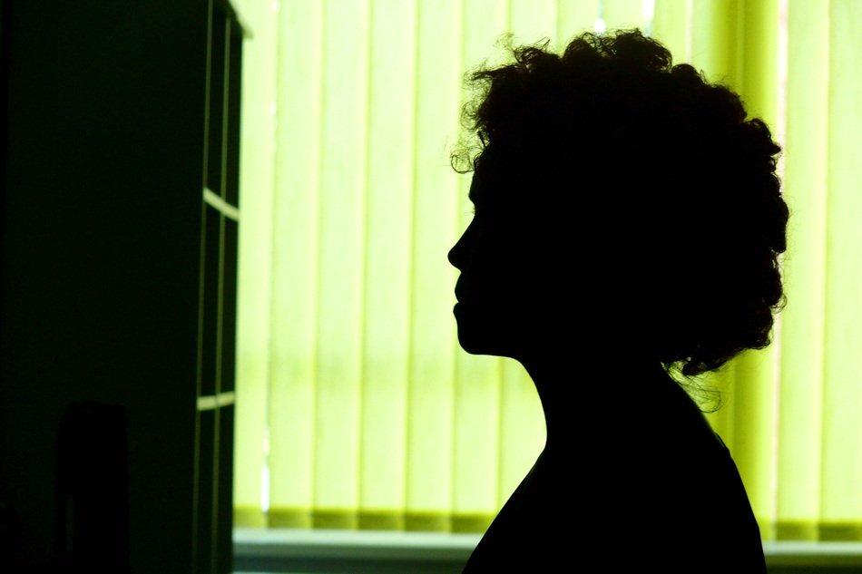 silhouette of a girl near the shelves