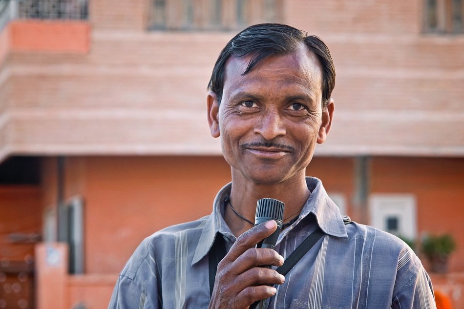 portrait of Hindu man with a microphone on a city street