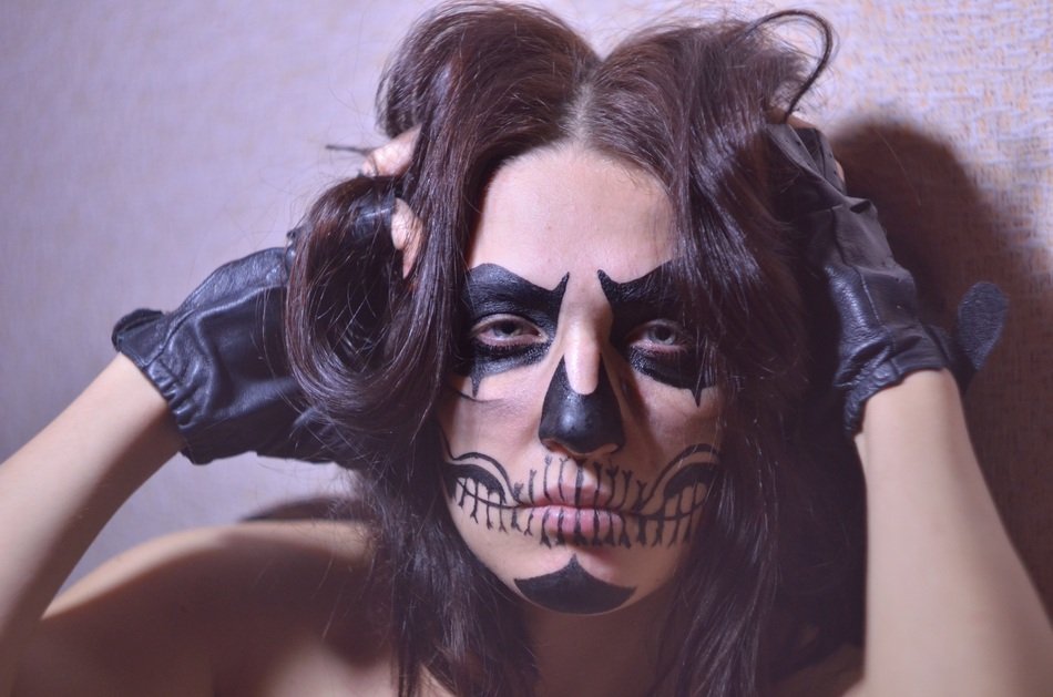 brunette with drawing on the face and gloves