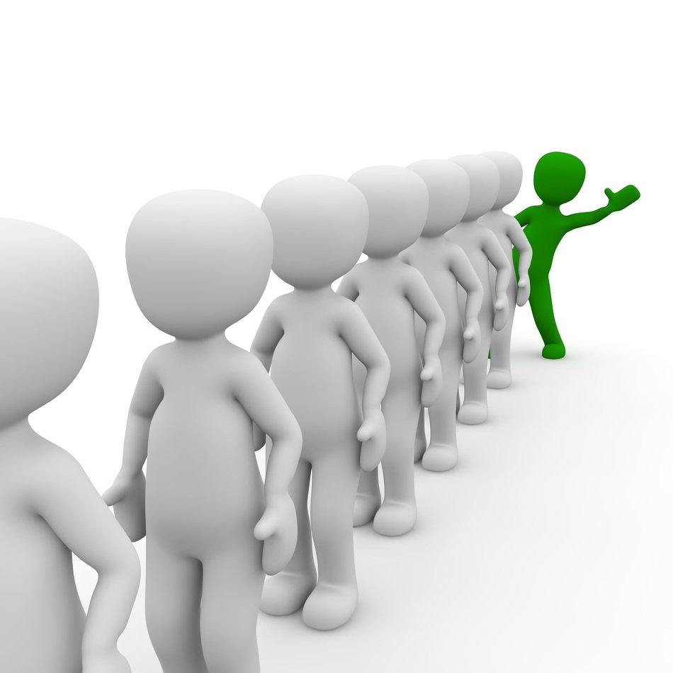green man shows his thumb at the end of a line of people