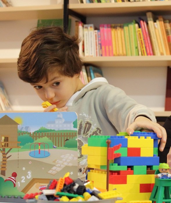 boy plays lego on the table