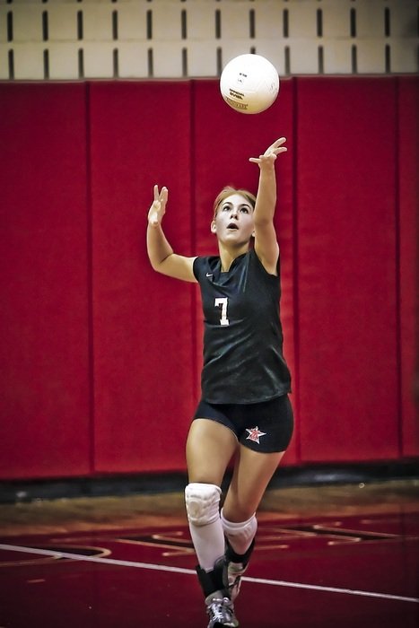boy in black uniform plays volleyball