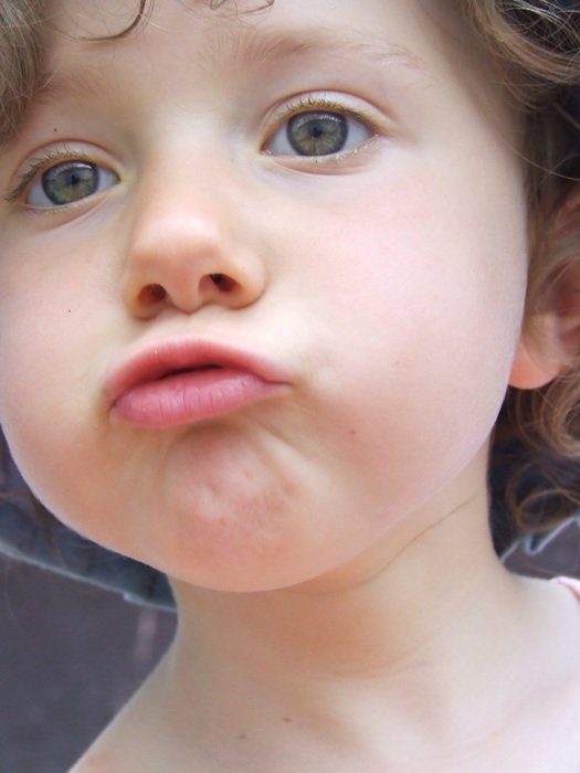 portrait of a child with outstretched mouth