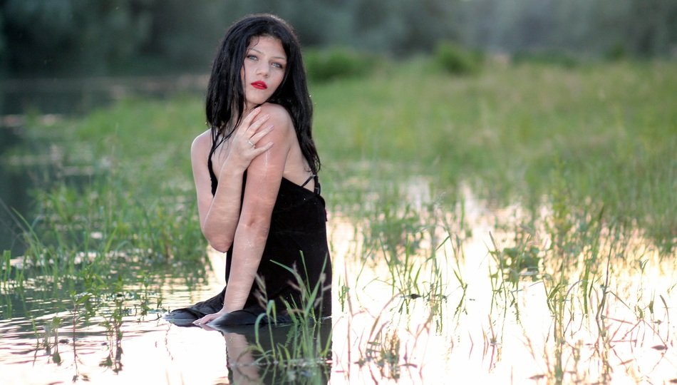 girl in a black dress in the water