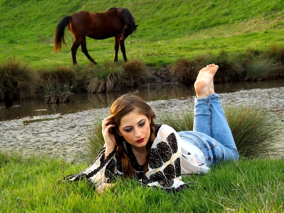 girl and horse near the water