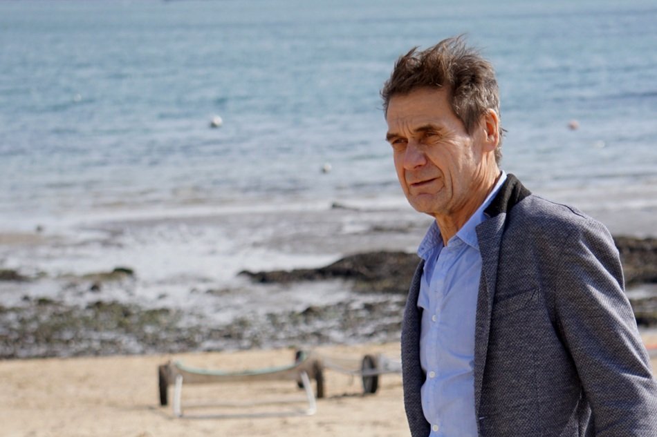man in a suit on the beach
