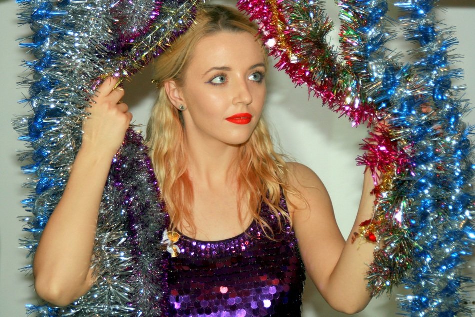 girl in colorful Christmas tinsel