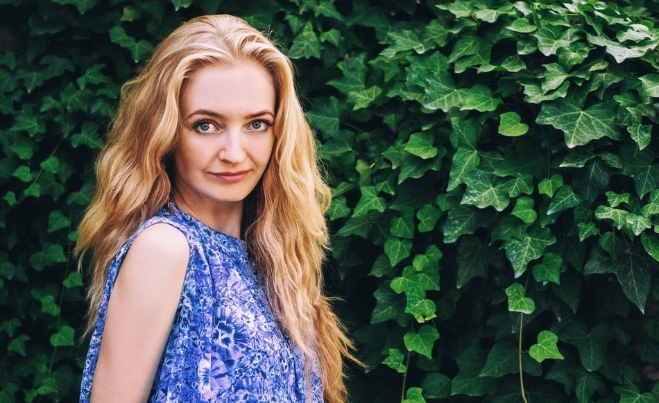 portrait of a girl on the background of a green bush