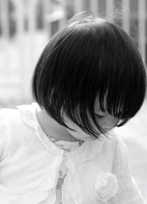 Black and white photo of the child with the black hair