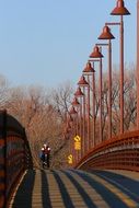 male Bicycle Rider on bridge at winter