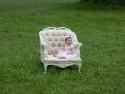 little girl sitting on the armchair