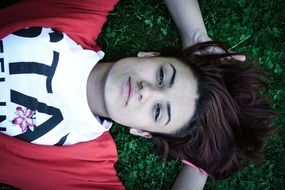 brunette relaxes on the lawn