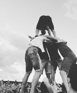 black and white photo of people making a pyramid