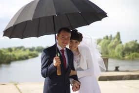 Married couple under the umbrella in summer