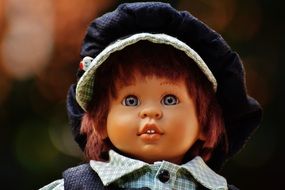 Children's toy in the form of a doll in a cap