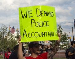 man with a poster at a rally in baltimore